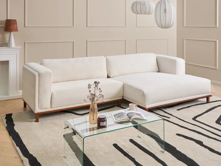 4-seater off-white bouclé corner sofa left orientation with soft textured upholstery and stable wooden frame