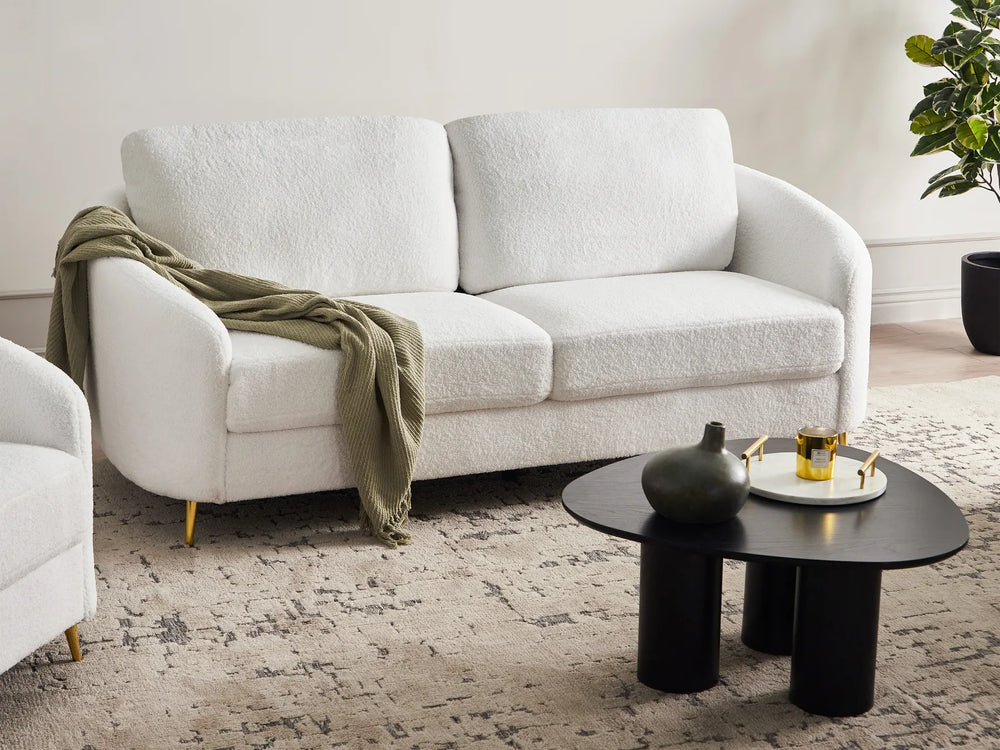 White bouclé three seater sofa with soft textured upholstery
