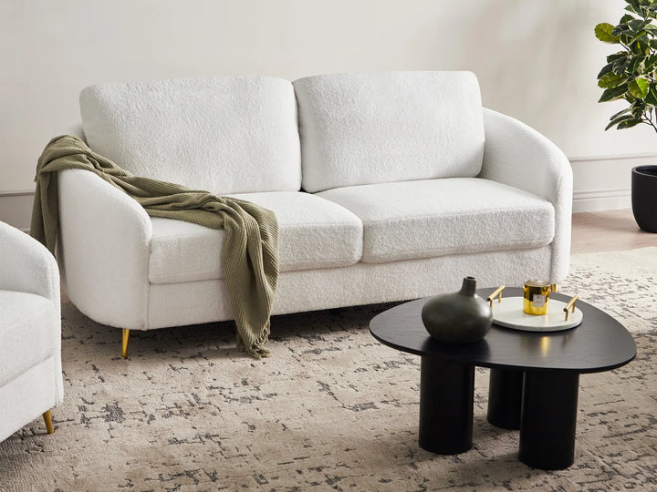 White bouclé three seater sofa with soft textured upholstery