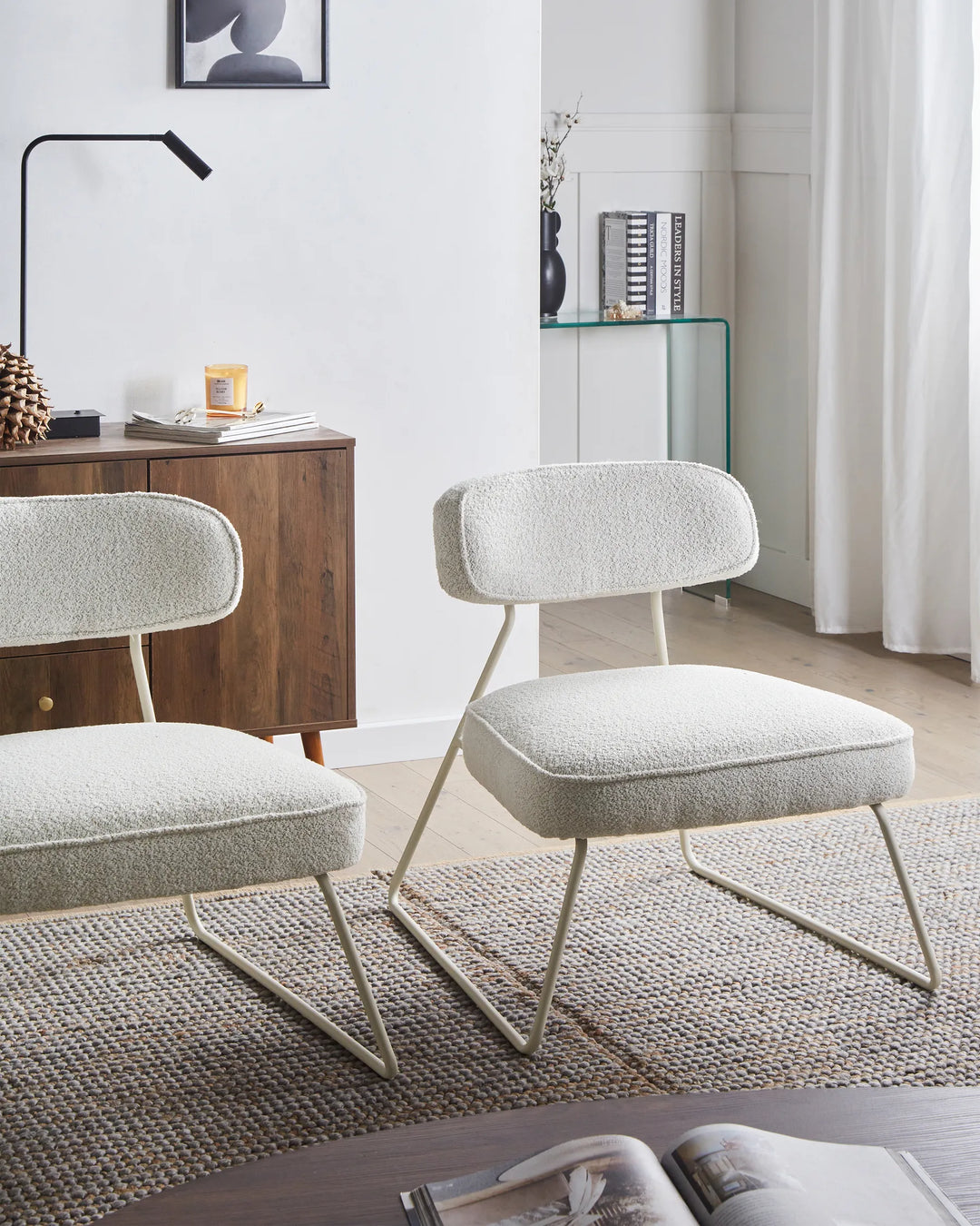 Modern living room with two gray chairs and a wooden side table.
