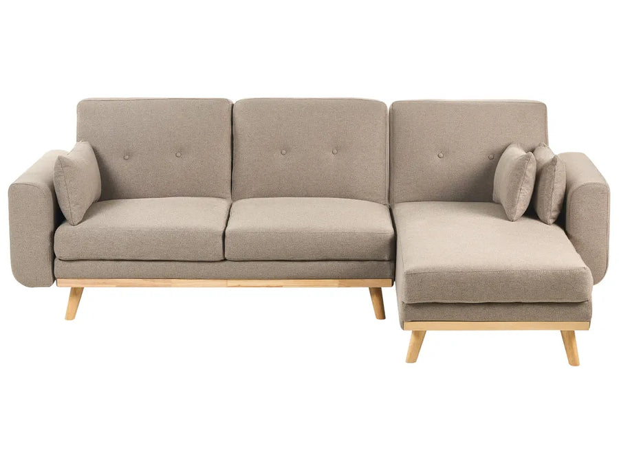 Beige sectional sofa with wooden legs on a white background