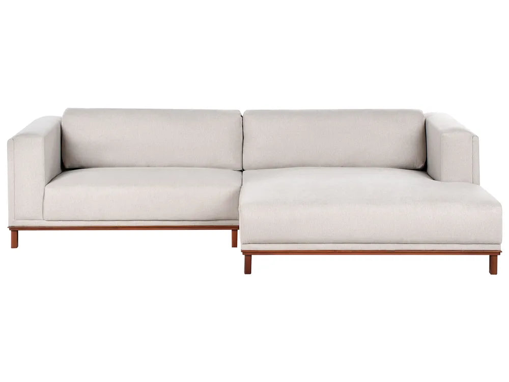 Light beige fabric left‑hand corner sofa with water‑repellent upholstery and wooden legs in a modern living room