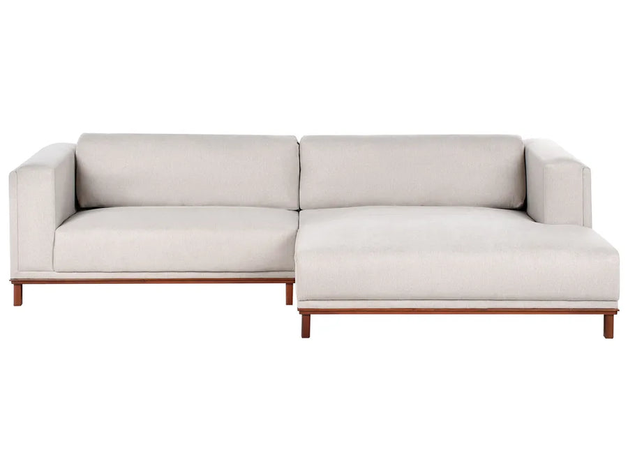 Light beige fabric left‑hand corner sofa with water‑repellent upholstery and wooden legs in a modern living room