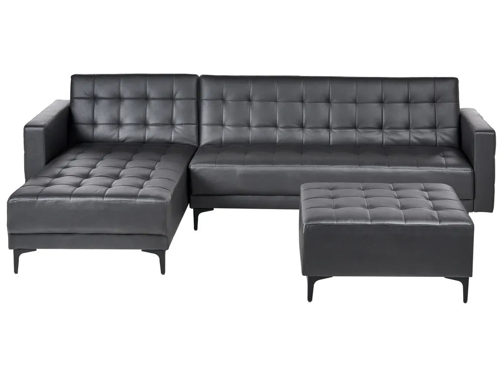 Gray tufted sectional sofa with ottoman on a white background