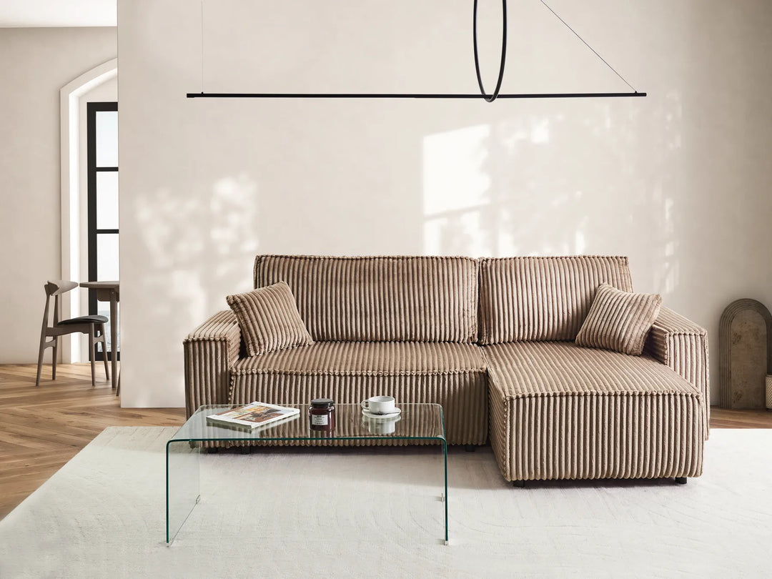 Modern living room with a striped sofa and glass coffee table.