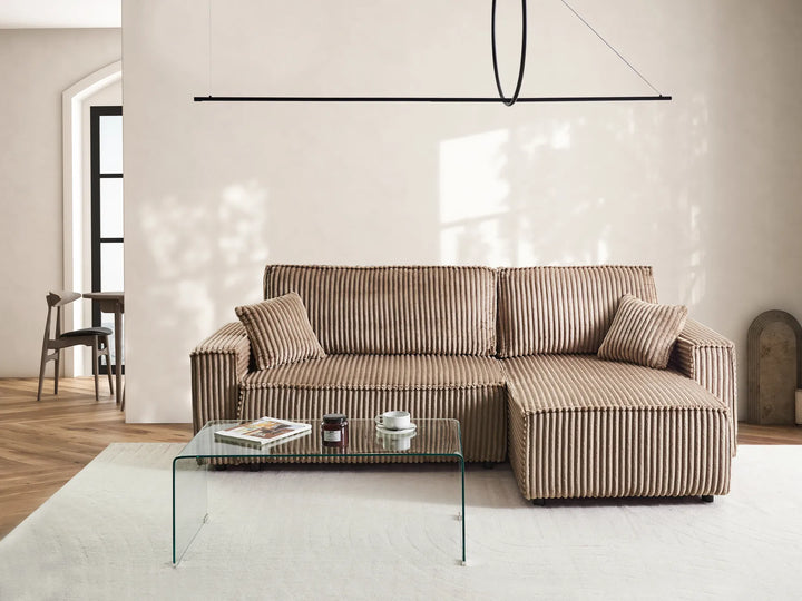 Modern living room with a striped sofa and glass coffee table.