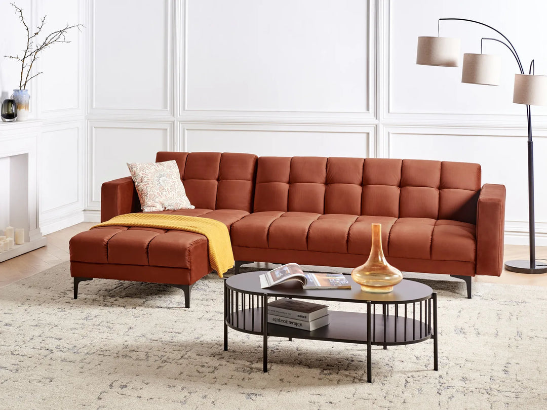 Brown sectional sofa in a living room with a coffee table and decor items.