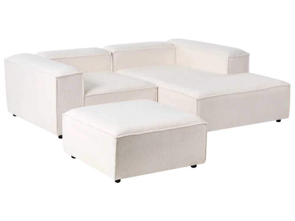 Off-white bouclé left-hand 3-seater modular corner sofa with ottoman in a modern living room