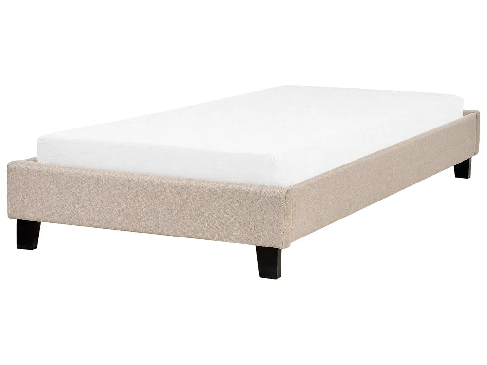 Beige upholstered bed frame with white mattress on a white background