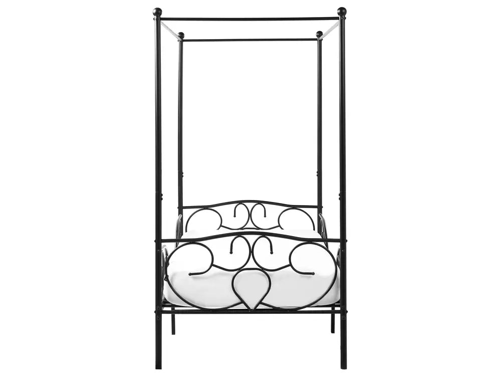 Decorative metal bed with heart designs on a white background