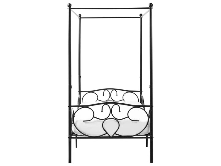 Decorative metal bed with heart designs on a white background