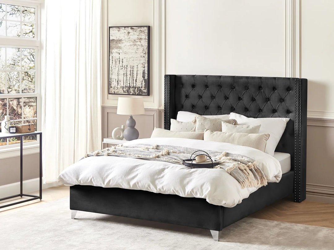 Upholstered velvet bed with button tufting and nailhead trim