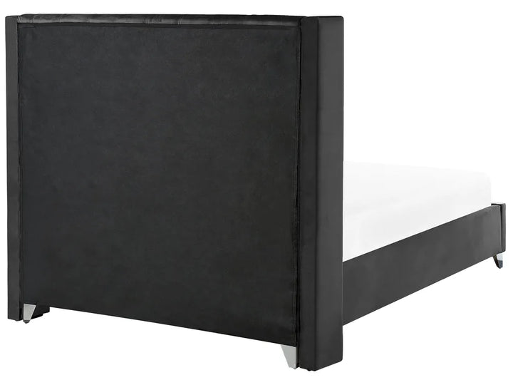 Elegant velvet bed with silver legs and padded headboard