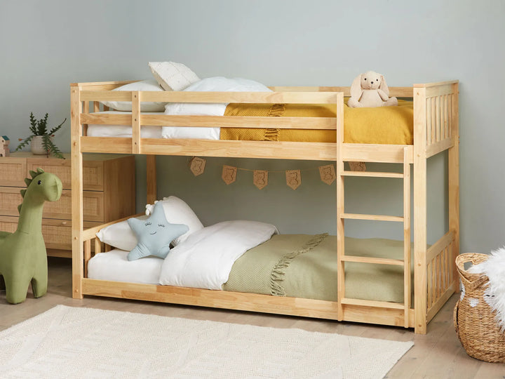 Wooden bunk bed with toys in a child's room
