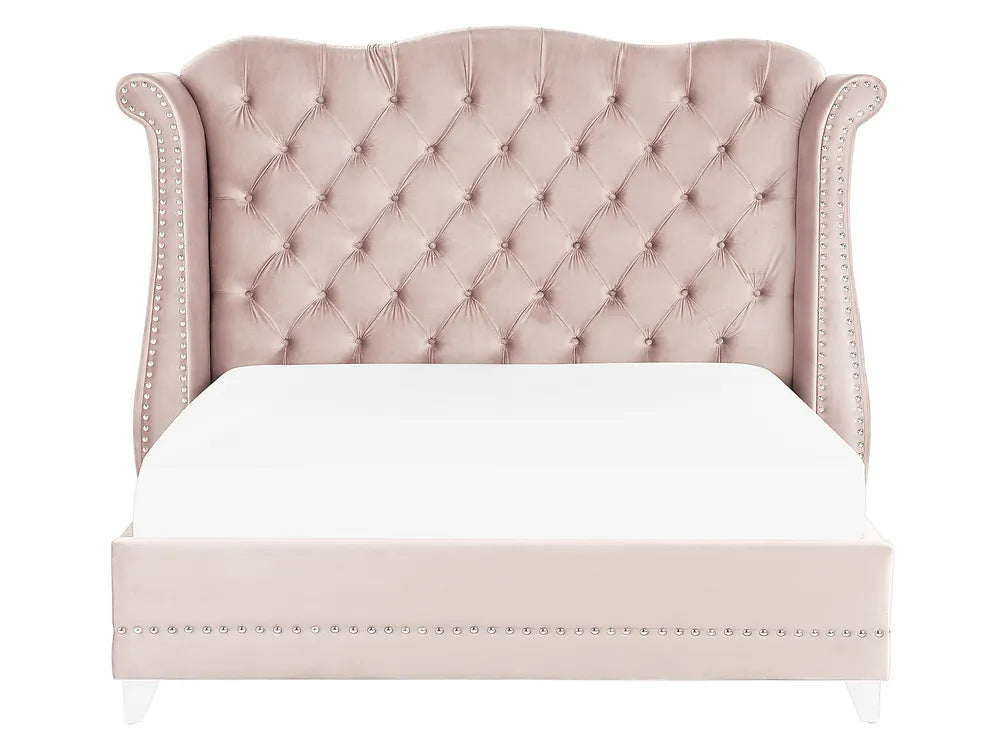 Luxury pink velvet bed with nailhead trim