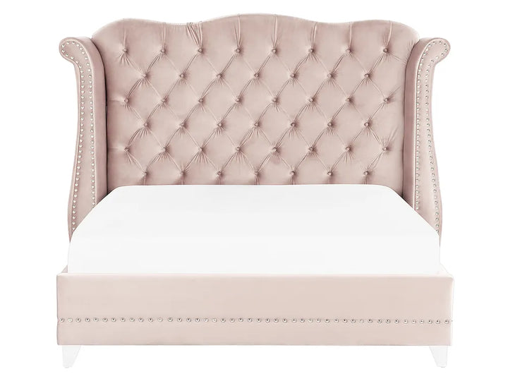 Luxury pink velvet bed with nailhead trim