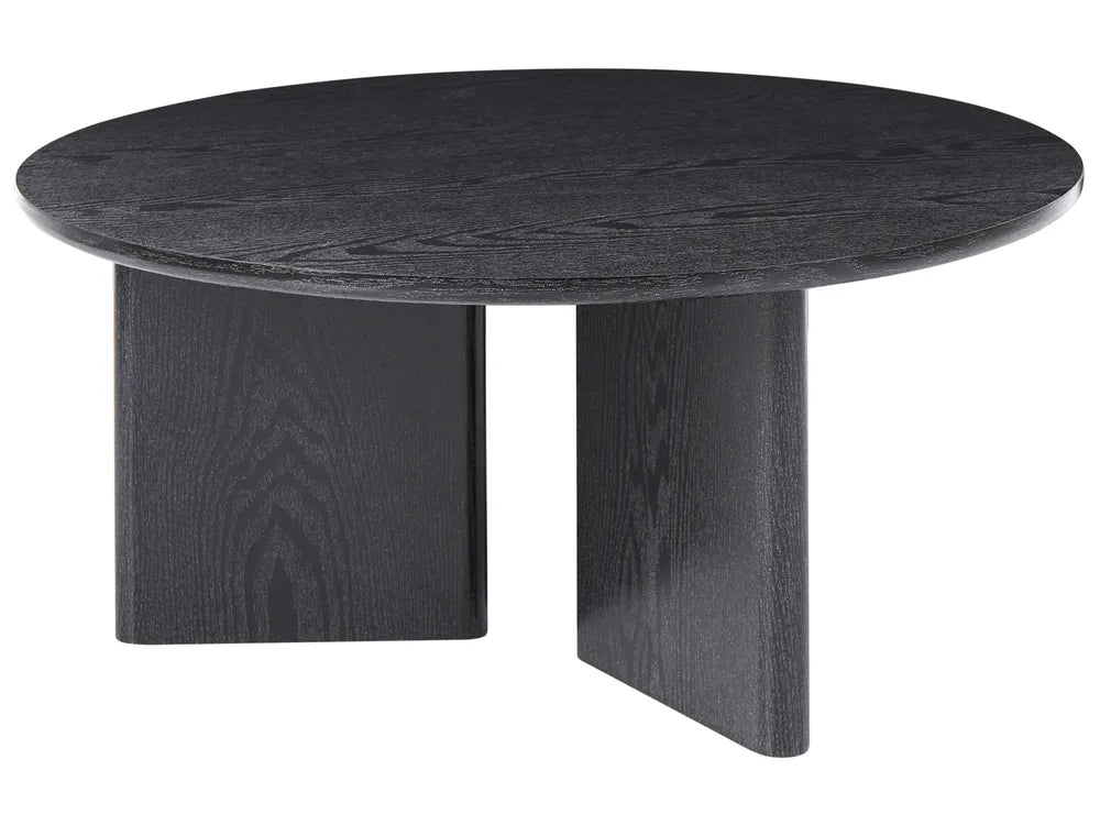 Round black table with a textured surface on a white background