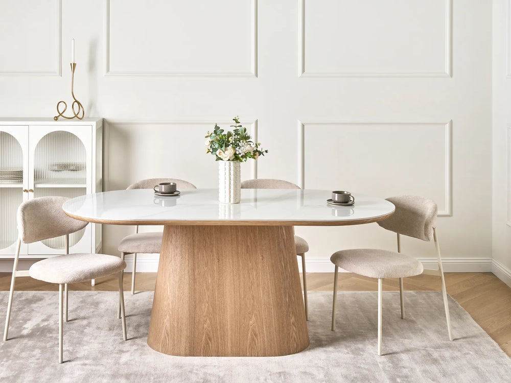 Dining room with a wooden table and chairs in a modern interior setting.