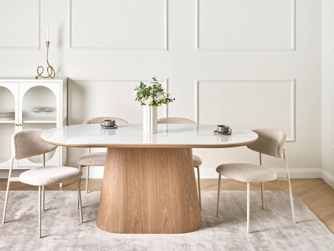 Dining room with a wooden table and chairs in a modern interior setting.