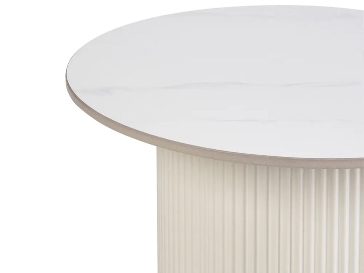 Close-up of a round white table with a ribbed beige base on a white background