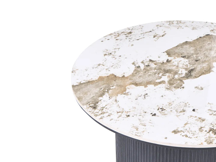 Round table with a distressed white and brown marble-like top on a white background