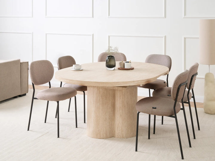 Dining room with a round wooden table and six chairs in a modern interior.