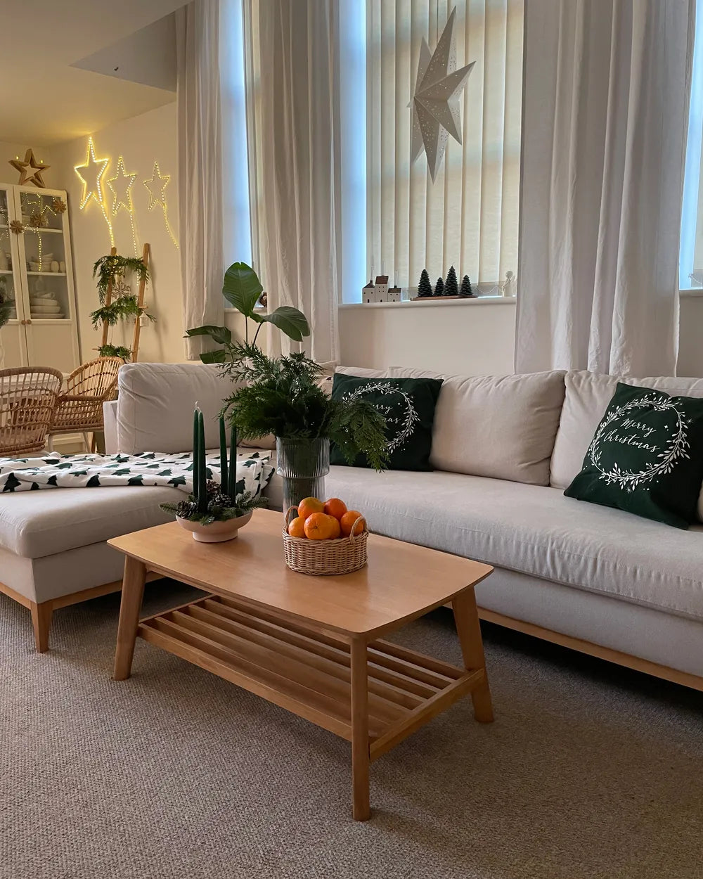 Living room with a white sofa, wooden coffee table, and decorative items.