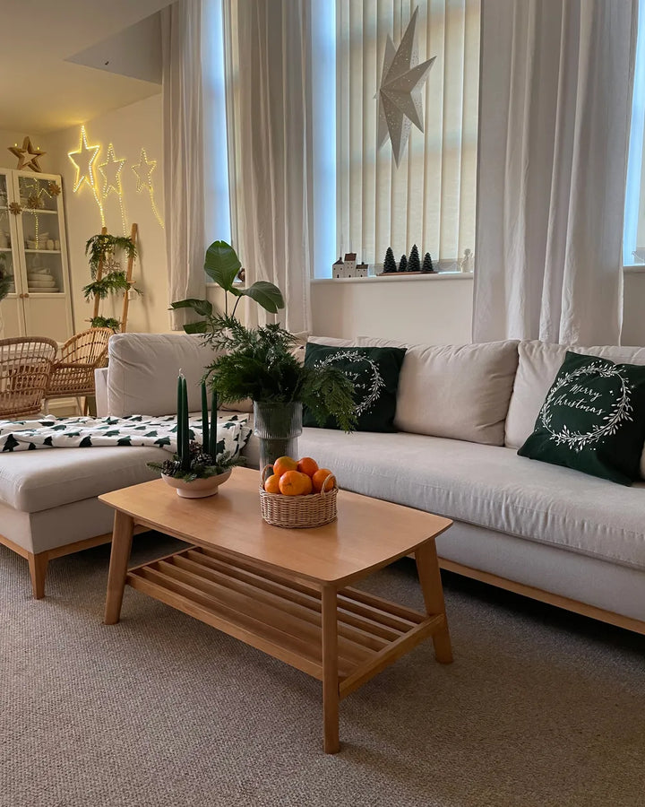Living room with a white sofa, wooden coffee table, and decorative items.
