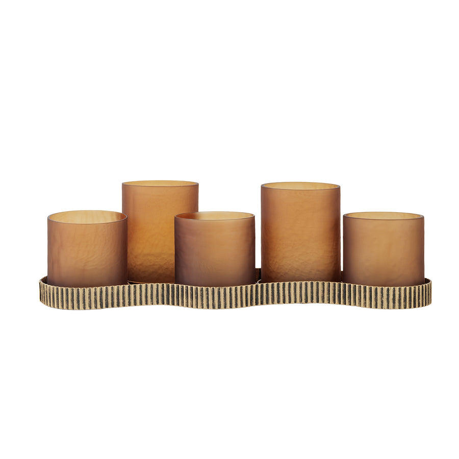 Set of five brown cylindrical candles on a decorative holder with a wavy edge on a white background