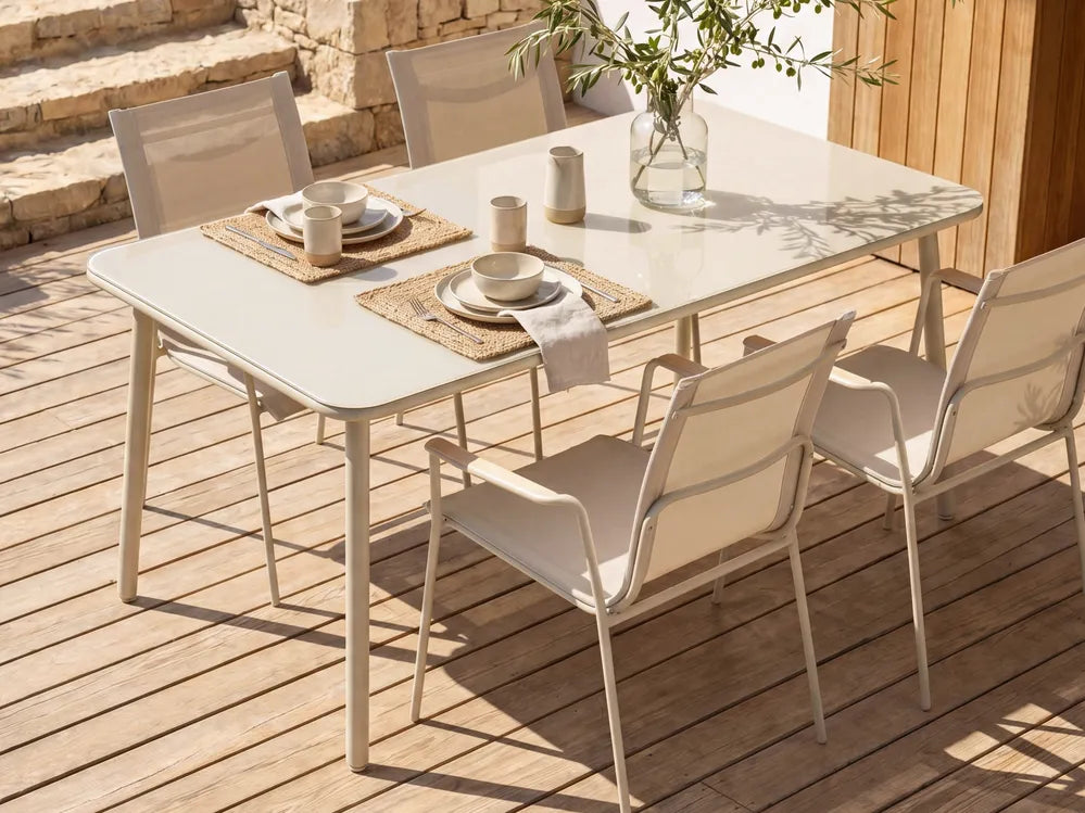 Outdoor dining table set with chairs on a wooden deck