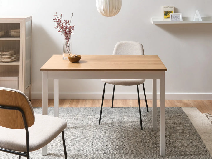 Dining room with a wooden table and chairs in a well-lit room.