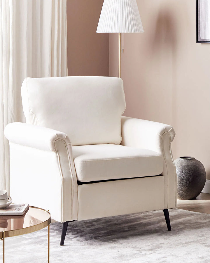 White armchair in a living room setting with a lamp and vase.