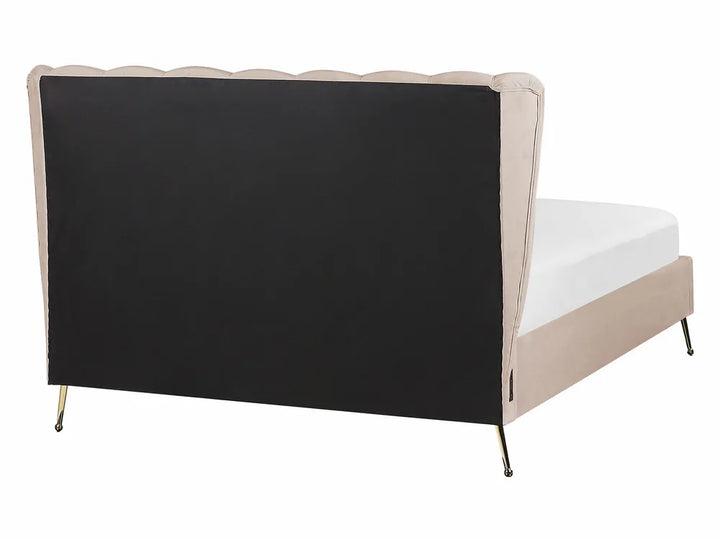 Bed with black headboard and beige frame on a white background