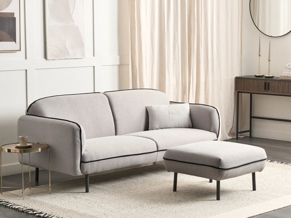 Gray sofa with matching ottoman in a living room setting