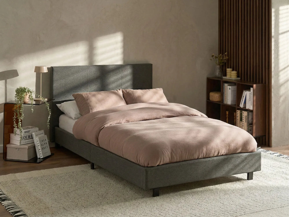 Bedroom with a bed, nightstands, and a bookshelf.