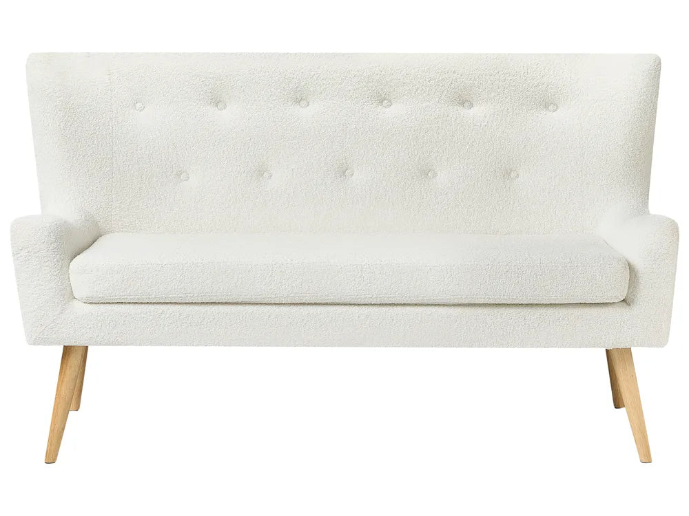 White tufted sofa with wooden legs on a white background