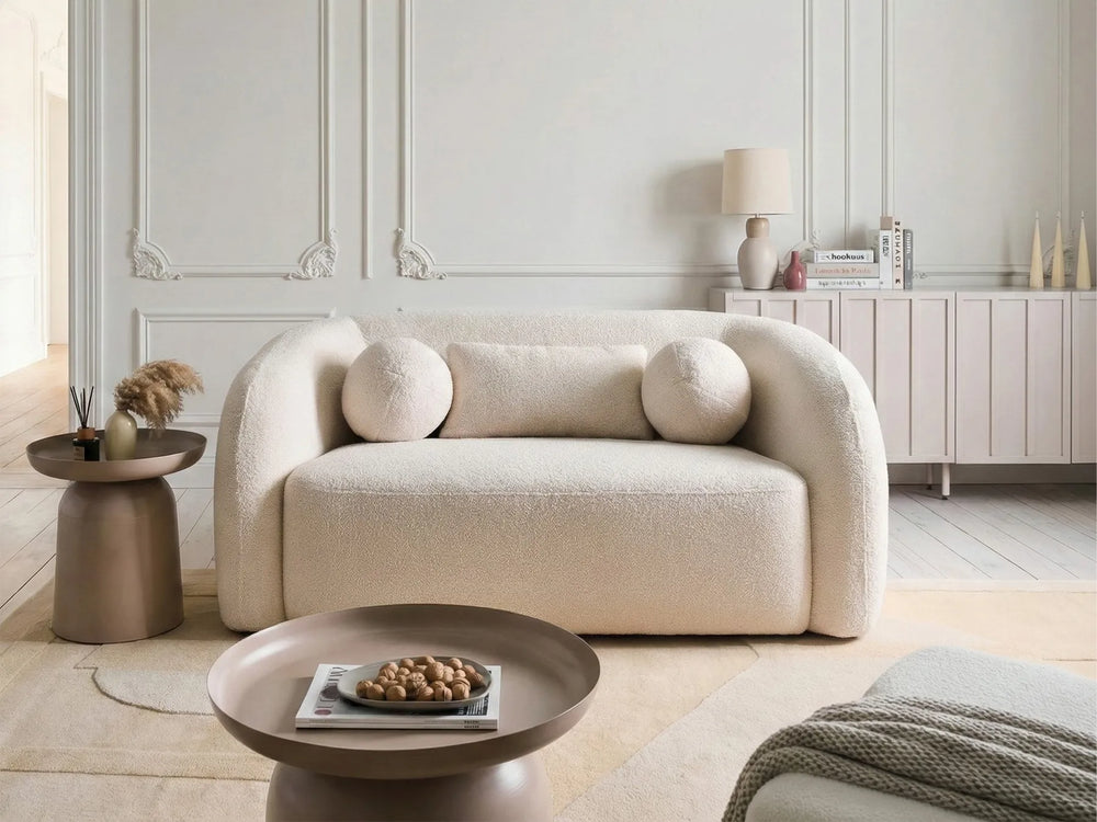 white bouclé loveseat with curved design