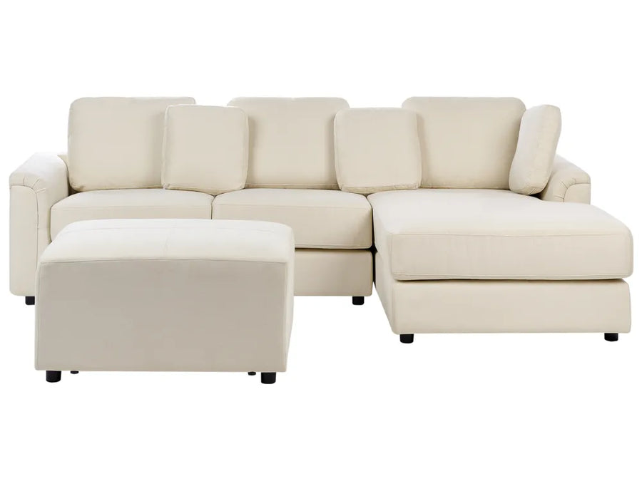 Beige sectional sofa with ottoman on a white background