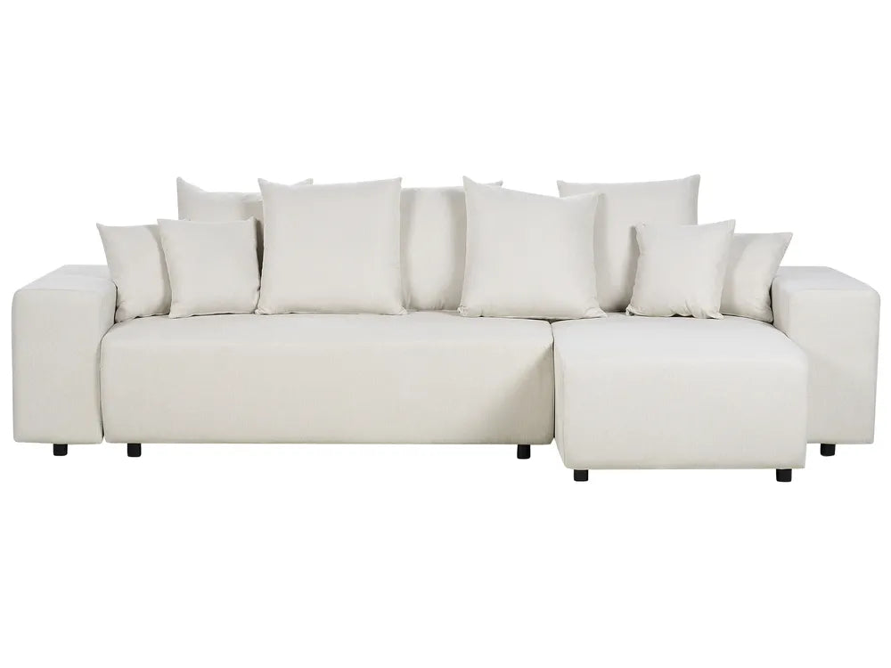 White sectional sofa with multiple cushions on a white background