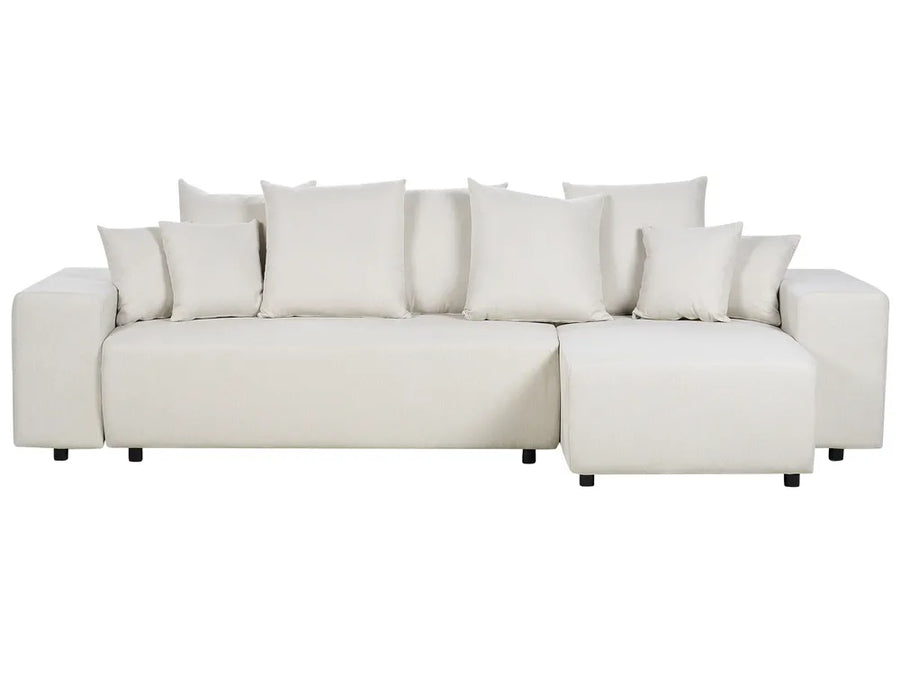 White sectional sofa with multiple cushions on a white background