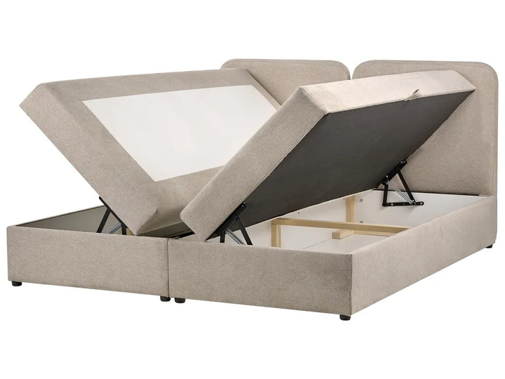 Beige upholstered bed with storage compartments on a white background