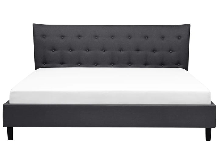 Black upholstered bed with white mattress on a white background