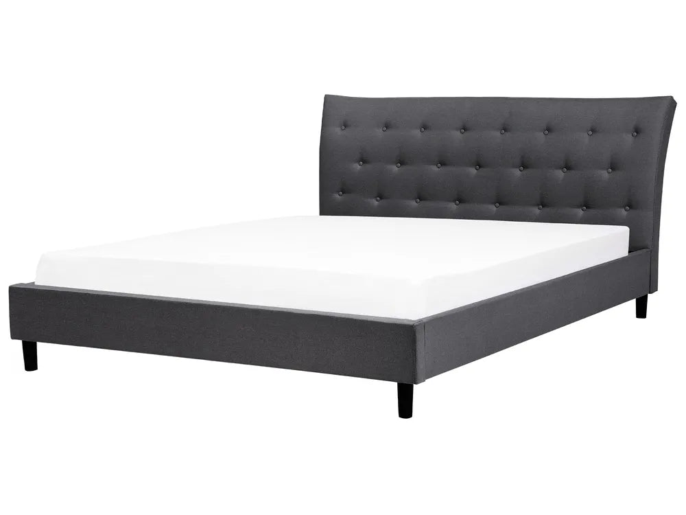 Gray upholstered bed with white mattress on a white background