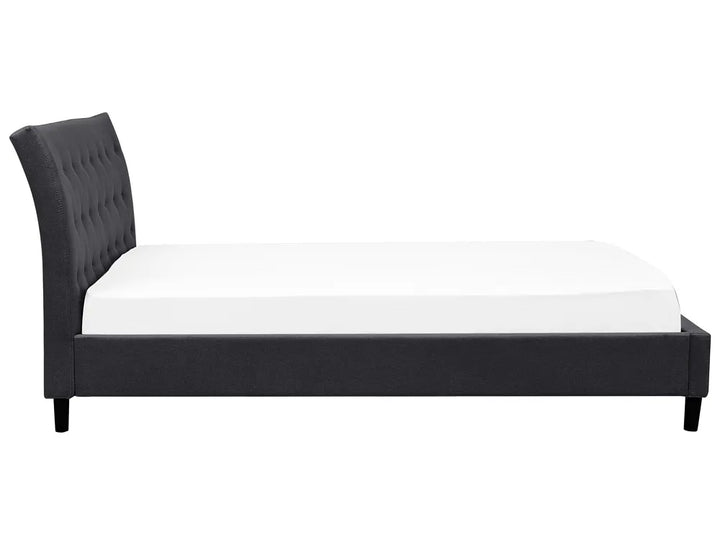Black upholstered bed frame with white mattress on a white background