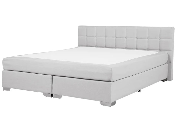 Gray upholstered bed with tufted headboard on a white background