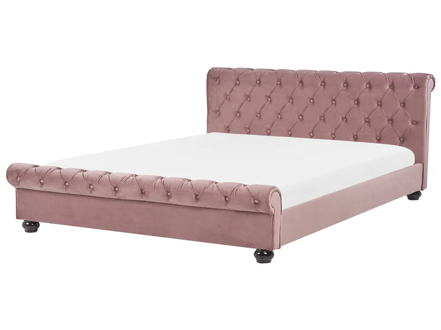Pink tufted bed with white mattress on a white background