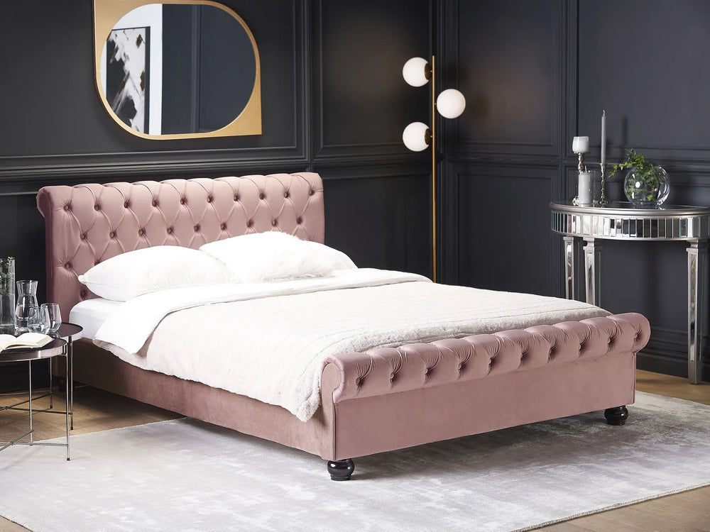 Pink upholstered bed in a stylish bedroom with dark walls and modern decor.