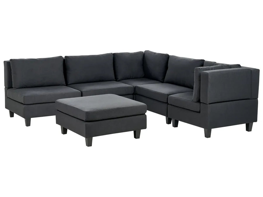 Gray sectional sofa with ottoman on a white background