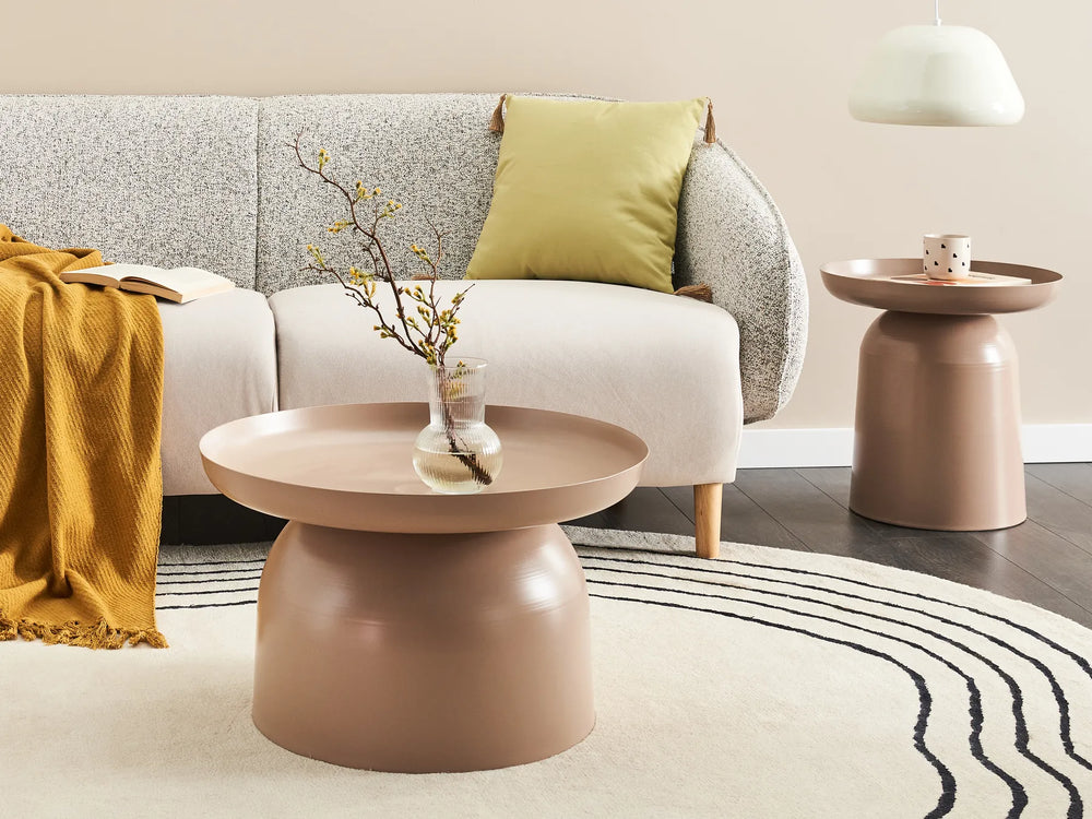Modern living room with a gray sofa, pink side table, and yellow blanket.