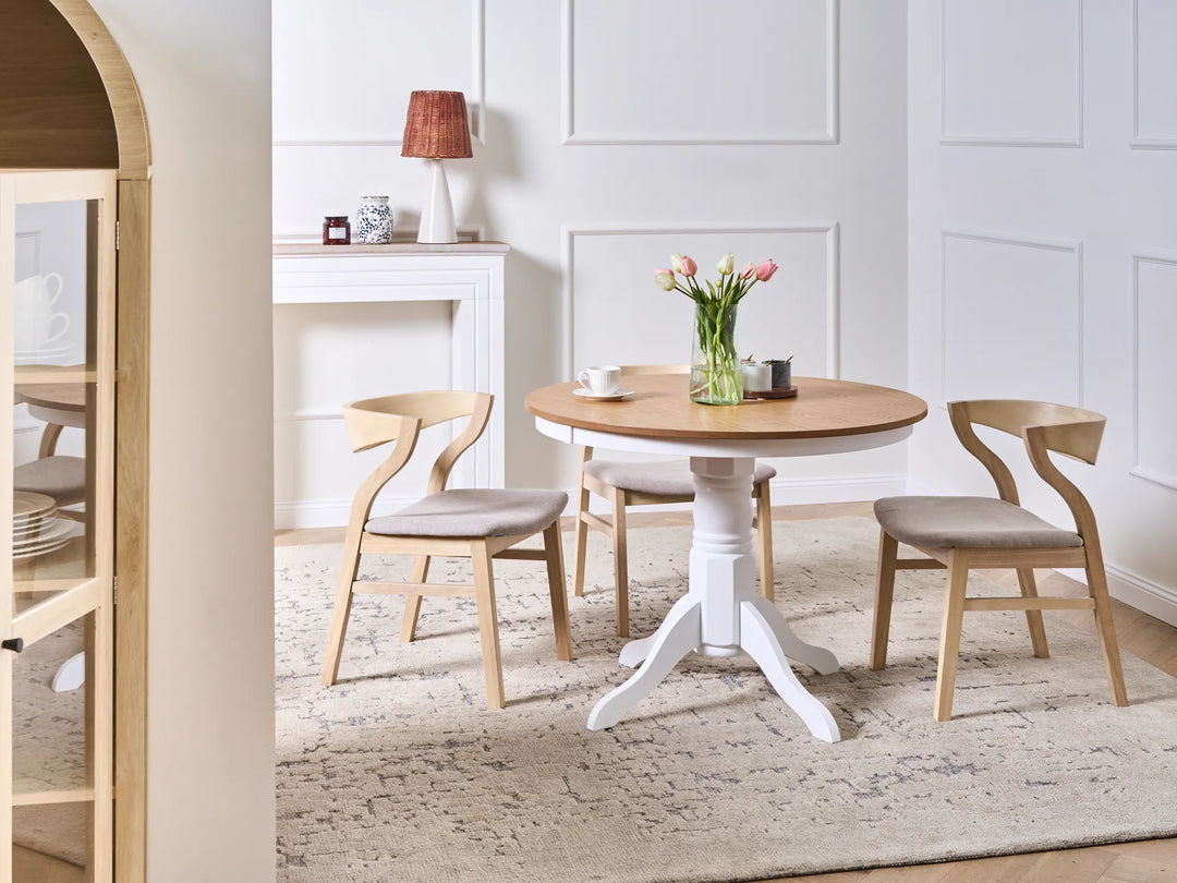 Dining room with a wooden table and chairs in a well-lit room.